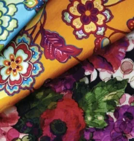 Rolls of printed floral fabric in orange, teal and red