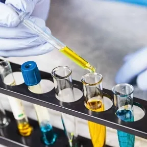 Pipette dispensing ink into laboratory test tubes