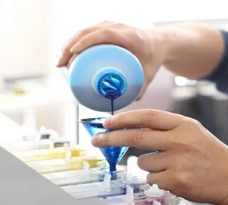 Blue ink being poured through a funnel in the laboratory