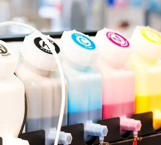 Cyan, magenta, yellow and black ink bottles on a printer